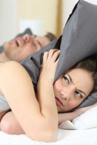 Woman whose husband is snoring