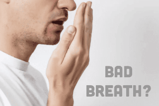 Man checking to see if he has bad breathe